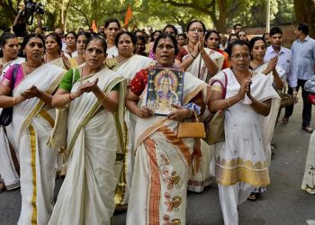 Indian Hindu women chant religious hymns worshipping Lord Ayyappa, the deity of Sabarimala temple, as they arrive for a protest against a recent Supreme Court verdict in New Delhi, India, Sunday, Oct.7, 2018. The historic Sabarimala temple had barred women of menstruating age from entering the temple. India's Supreme Court on September 28th lifted the ban, holding that equality is supreme irrespective of age and gender. Hundreds of protestors gathered near the Indian Parliament Sunday demanding that the customs and rituals of the temple should not be changed. (AP Photo/R S Iyer)