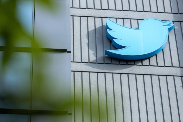 (FILES) The Twitter logo is seen on a sign on the exterior of Twitter headquarters in San Francisco, California, on October 28, 2022. Australia's internet safety watchdog on June 22, 2023 threatened to fine Twitter for failing to tackle online abuse, saying Elon Musk's takeover had coincided with a spike in "toxicity and hate". (Photo by Constanza HEVIA / AFP)