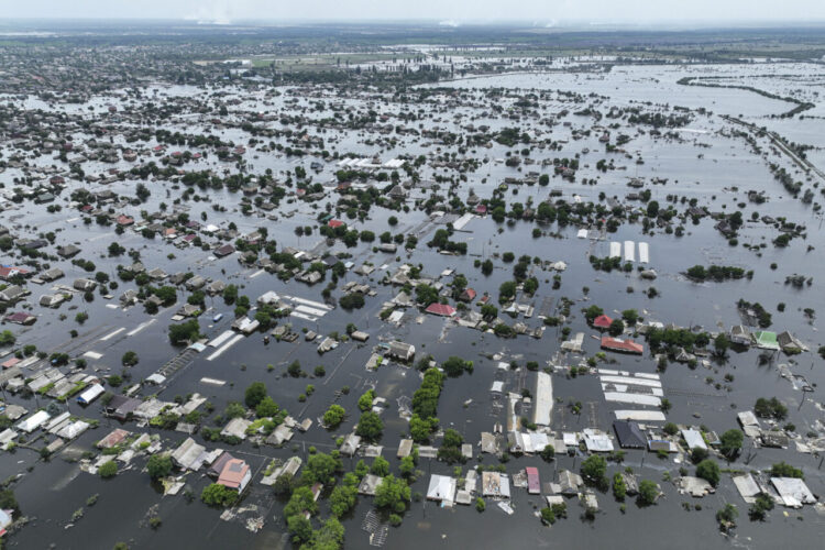 Houses are seen underwater in the flooded town of Oleshky, Ukraine, Saturday, June 10, 2023. The destruction of the Kakhovka Dam in southern Ukraine is swiftly evolving into long-term environmental catastrophe. It affects drinking water, food supplies and ecosystems reaching into the Black Sea.  (AP Photo)