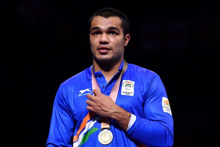 Gold medallist India's Vikas Krishan attends the medal ceremony for the men's 75kg boxing event during the 2018 Gold Coast Commonwealth Games at the Oxenford Studios venue on the Gold Coast on April 14, 2018. / AFP PHOTO / Anthony WALLACE