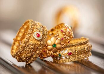 Fancy designer antique golden bracelets for woman fashion studio shot.